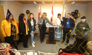 Bob Gloade, chief of Millbrook First Nation (second from right), and Karen Pictou, executive director of Nova Scotia Native Women's Association (third from right), cut the ribbon at an opening ceremony