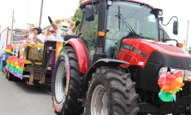 Tractor pulling a parade float at Truro Pride