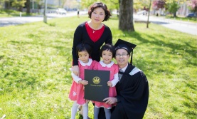 Student, spouse, and two children at convocation