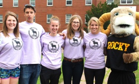 Five student orientation volunteers with Rocky the Ram