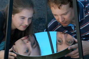 Theresa Mader and Dr. Tom Duck examine one of the telescopes built by Theresa last summer