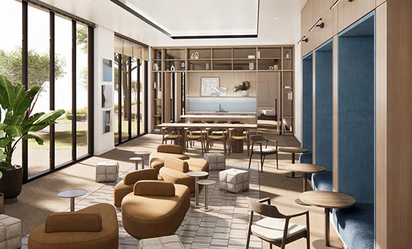 an indoor working space with many comfy chairs, large windows, and tables for work and collaboration