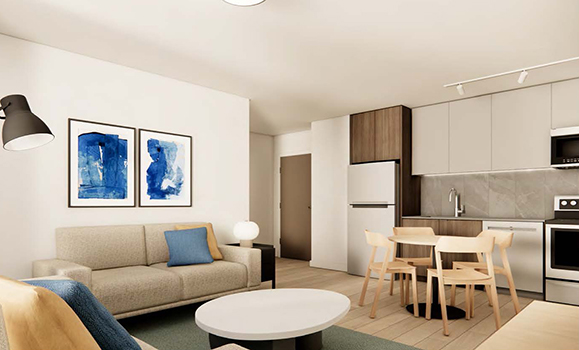 a cozy common living area with a couch, chair, kitchen table, and kitchen appliances