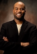 Headshot of Javiere, arms crossed and smiling. 