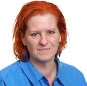 Headshot of Marijke, wearing a bright blue button-up shirt. 