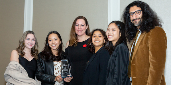 The McGill team poses with a Scotiabank representative, holding a trophy.