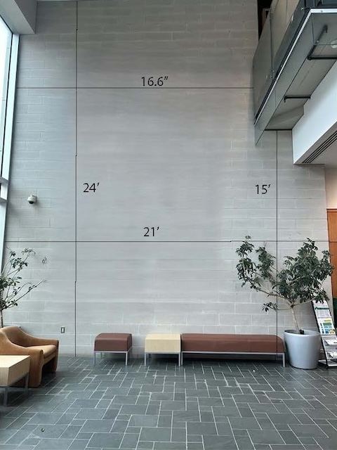 A wall in the Rowe building, showing a blank space where the artwork will appear with the dimensions marked.
