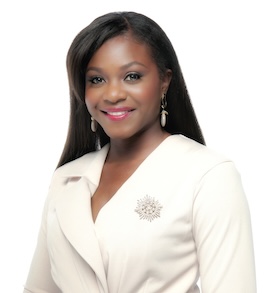 A headshot of Kenisha smiling and wearing white.