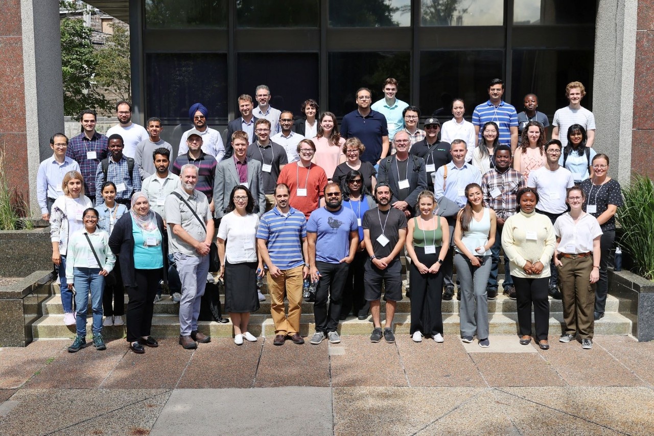 Members of the CTRI Research community stand outside in the sun, for the group photo.
