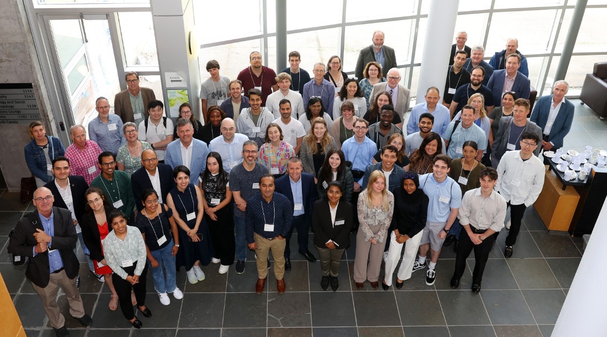 Members of the CTRI Research community stand outside in the sun, for the group photo.