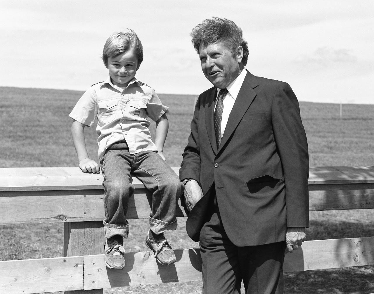 Allan J. MacEachen (right) stands with child