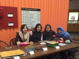 Nada (right, in blue) with colleagues at the DSSAS bakesale