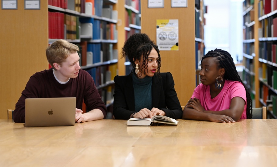 Three Schulich Law students study together at a table in the Dunn Law Library.