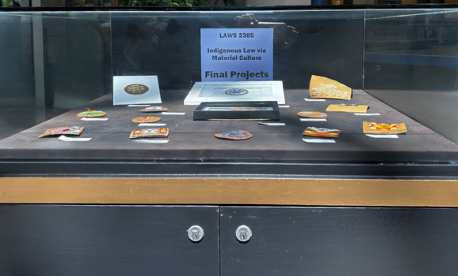 Display case featuring law students quillwork art pieces.