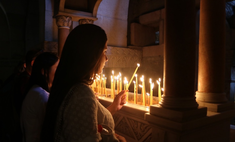 Program participant lighting candles at the Church of the Holy Sepulchre in Jerusalem