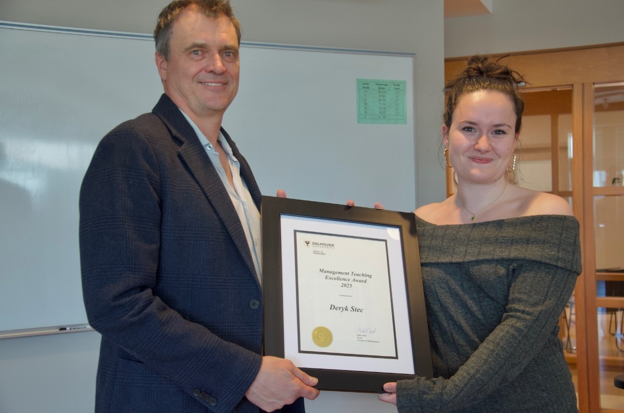 Dr. Stec and Brooklyn hold a teaching award certificate between them, smiling.