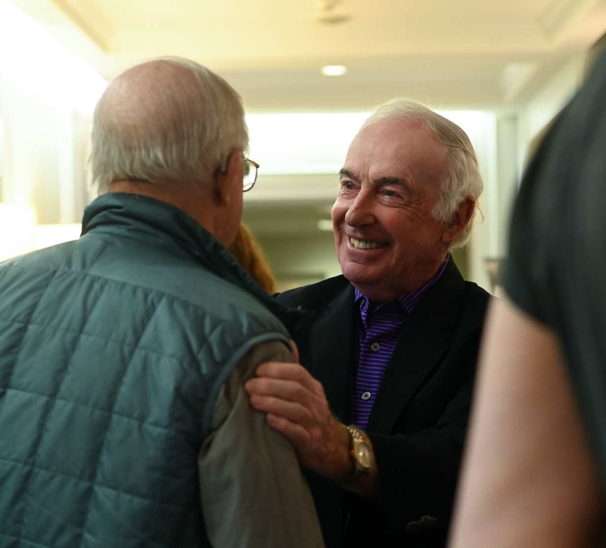 Dr. Barton greeting another attendee