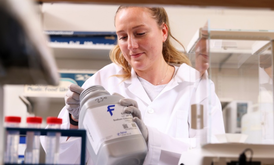 Student researcher weighing chemicals