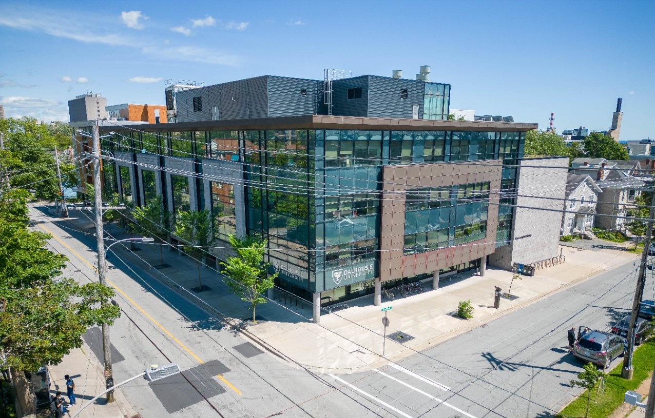 The Mona Campbell Building is seen from above on a sunny day, surrounded by empty crisscrossing streets.