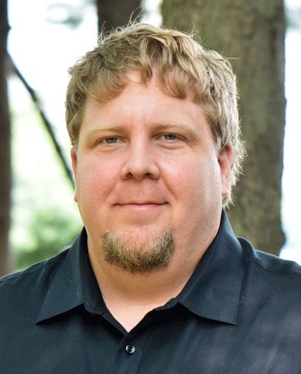 Nathan smiles. He has a light skin tone; short, light brown hair; and a small goatee. Nathan smiles. He has a light skin tone; short, light brown hair; and a small goatee.