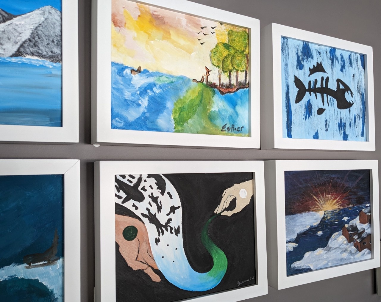 Six paintings hang together on a wall, with images including an icy Arctic sunrise/sunset, a black silhouetted fish skeleton, and a pair of hands guiding a trail of animal figures and bright coloured light through a dark sky.