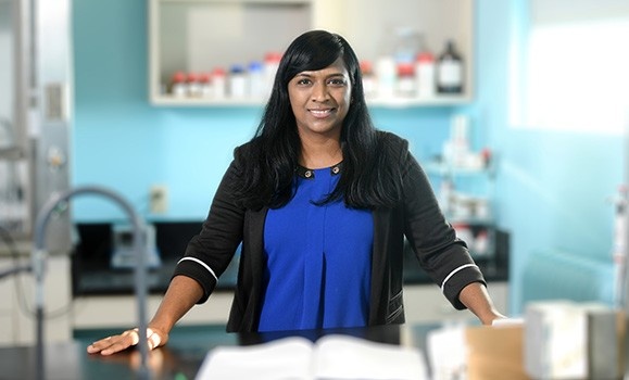 Mita Dasog standing at a table