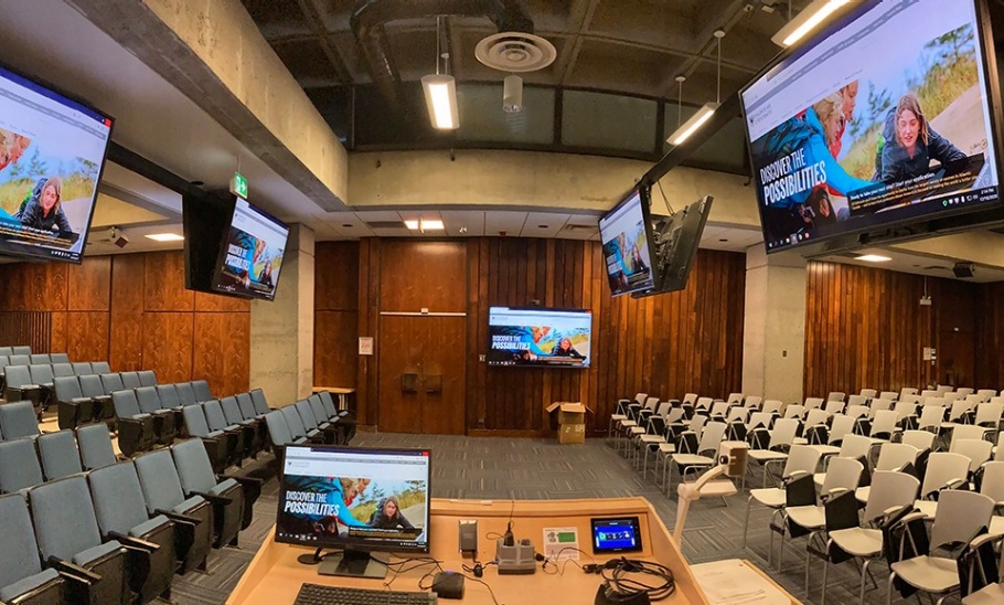 Interior of the MacMechan Auditorium with a number of large mounted monitors.