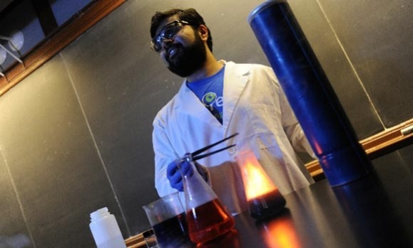 Graduate student Saurabh Chitnis causes a chemical reaction. Danny Abriel Photo. Graduate student Saurabh Chitnis causes a chemical reaction. Danny Abriel Photo.
