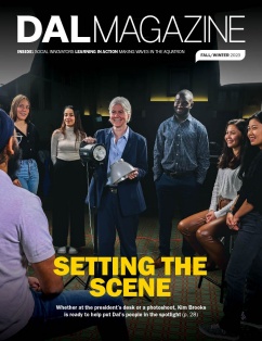 The cover of DAL Magazine features Dr. Brooks holding a stage light, smiling and surrounded by six Dal students. The magazine theme is 'SETTING THE SCENE'.