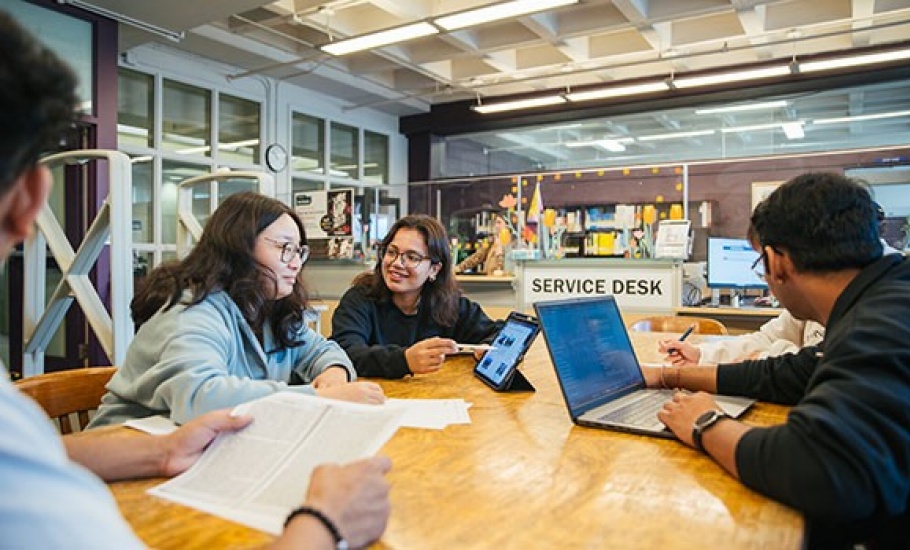 group of students working and studying together at a table