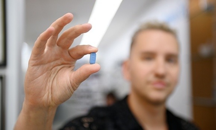 Dale Lemieux, a participant in the PrEP prescription study, holds one of the HIV prevention drugs