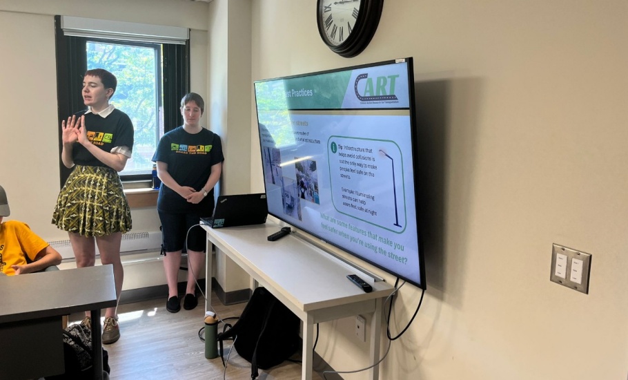 Zoe and Jen presenting the Share the Road Campaign to elementary school age children at ��ɫֱ��'s SuperNOVA Camp