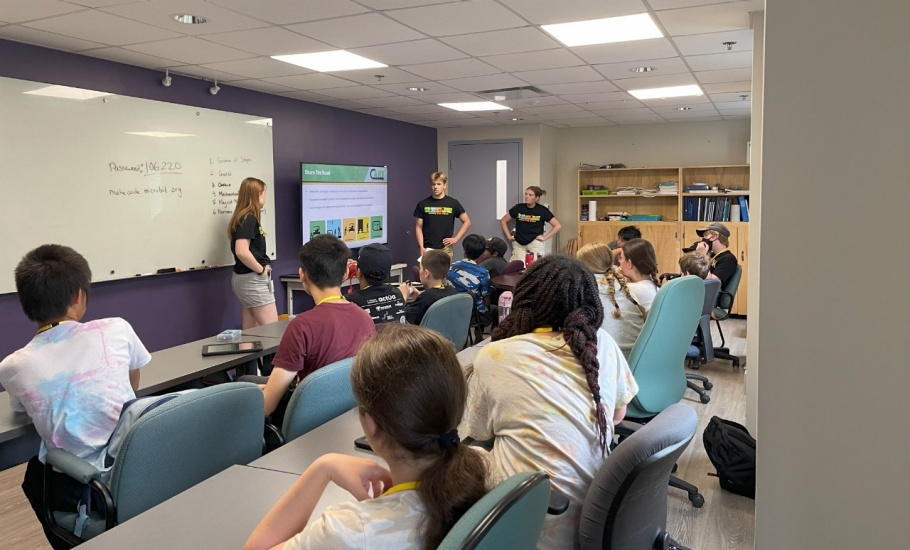 A group of children watching a presentation about the Share the Road campaign