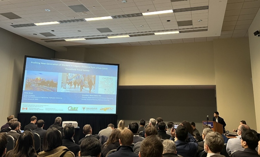 A group of people watching a presentation