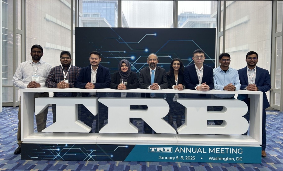 The DalTRAC team standing in front of the TRB Conference sign