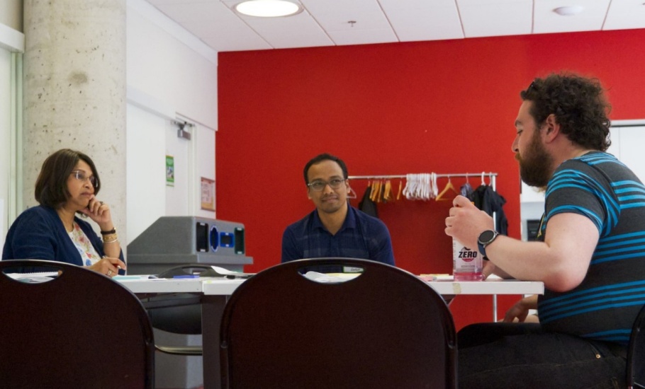 a group of people discussing ideas around a table