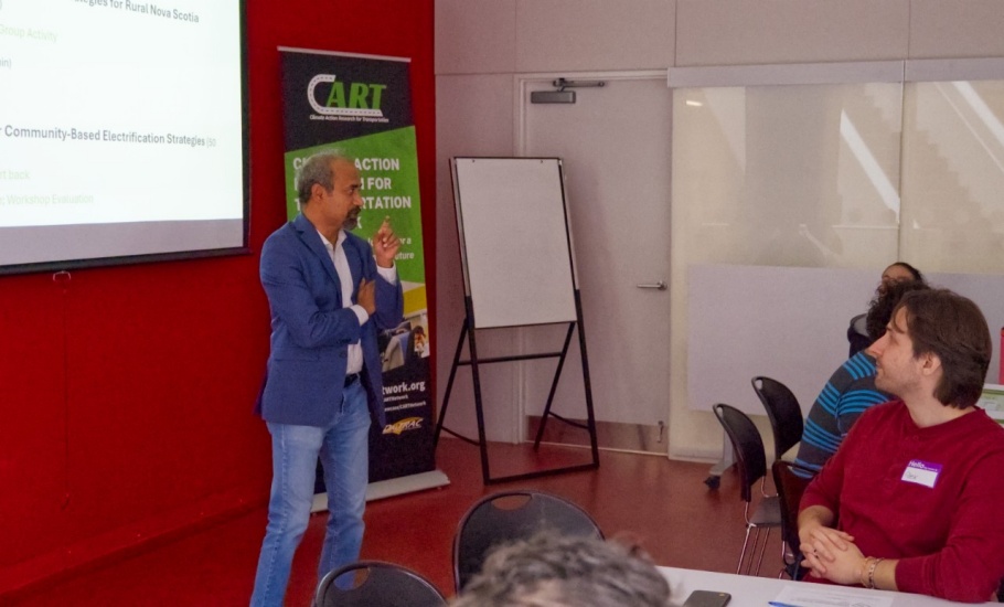 A man giving a presentation to a room of professionals