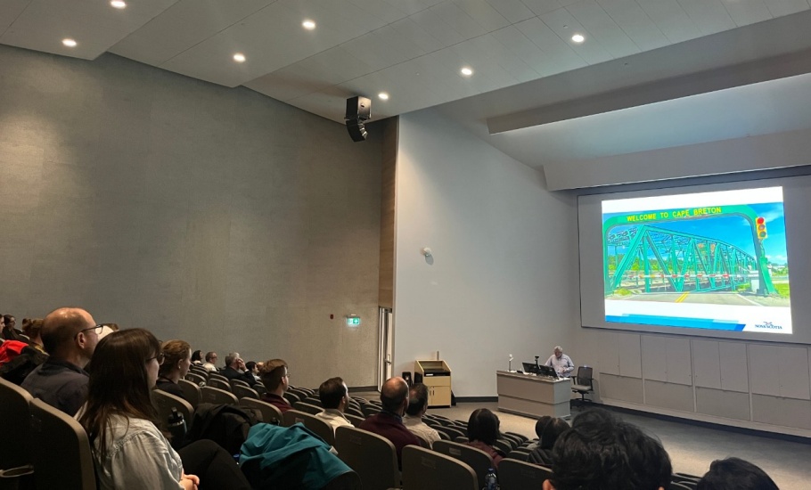 A large group of people watching a presentation