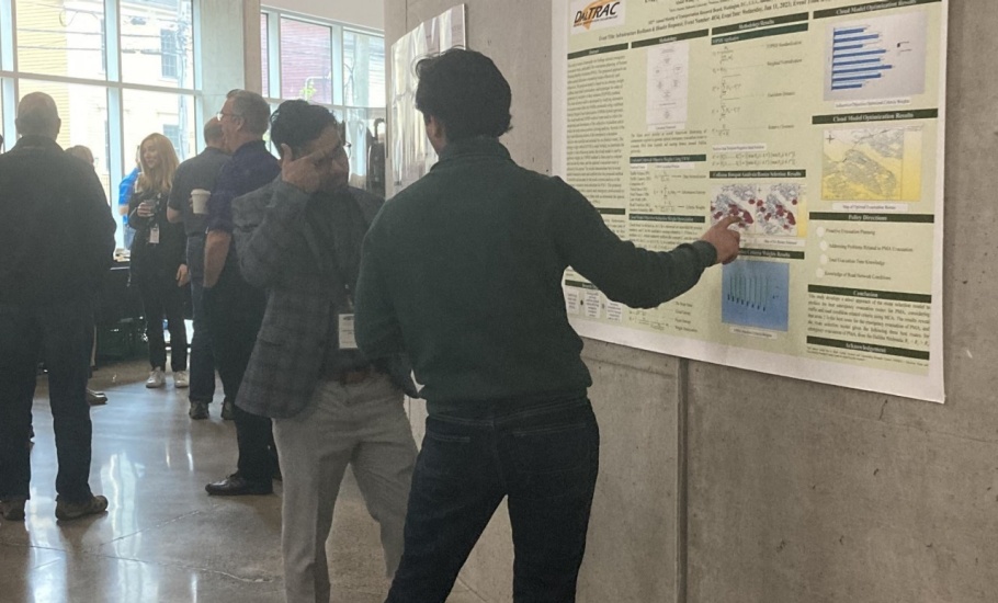 A man presenting his poster