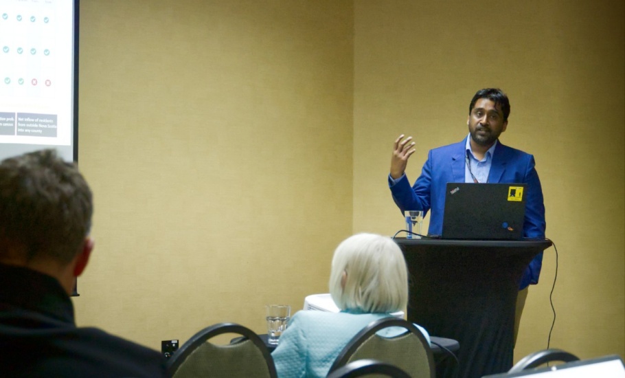 Vajeeran gives a presentation to a group of transportation professionals and researchers