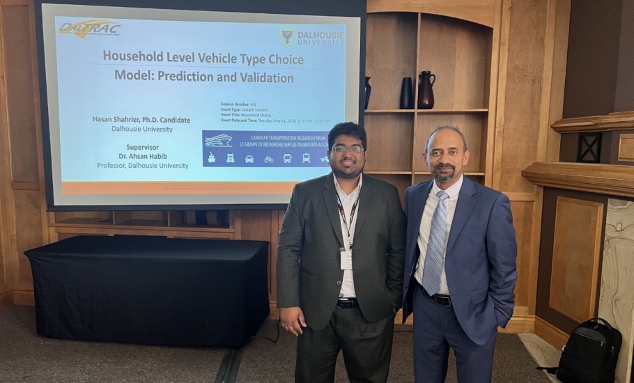 Two men standing in front of their presentation
