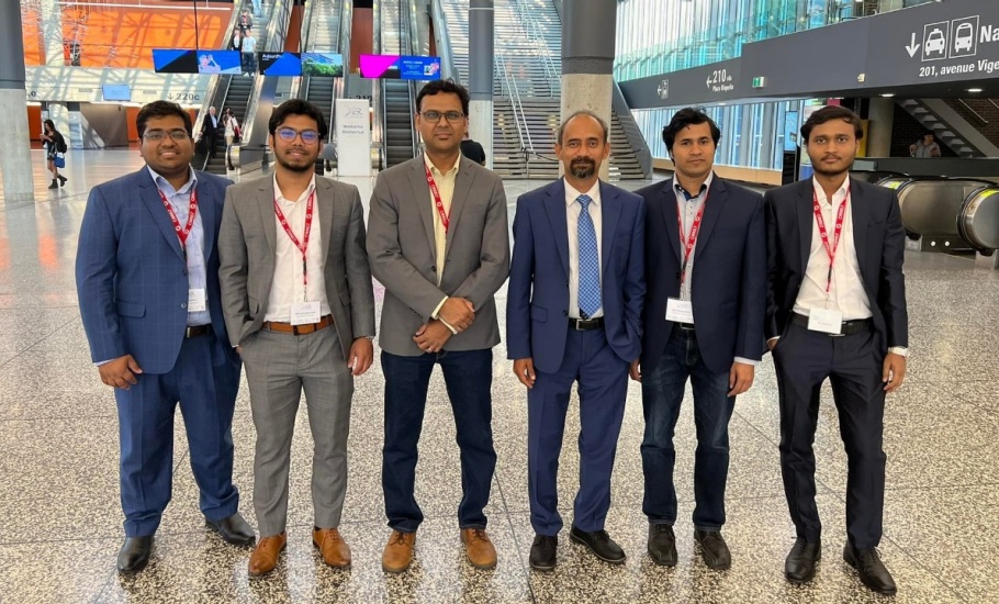 A group of people standing in a convention centre lobby
