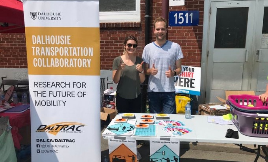 A man and woman standing at a table promoting the Share the Road Campaign