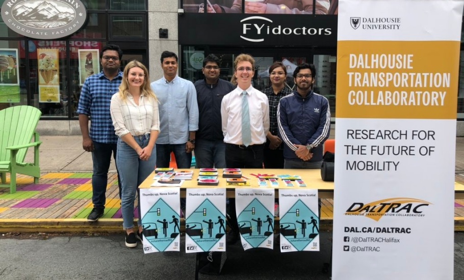 A group of DalTRAC students posing in front of the share the road booth