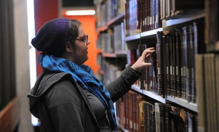 A student looks at books in the library