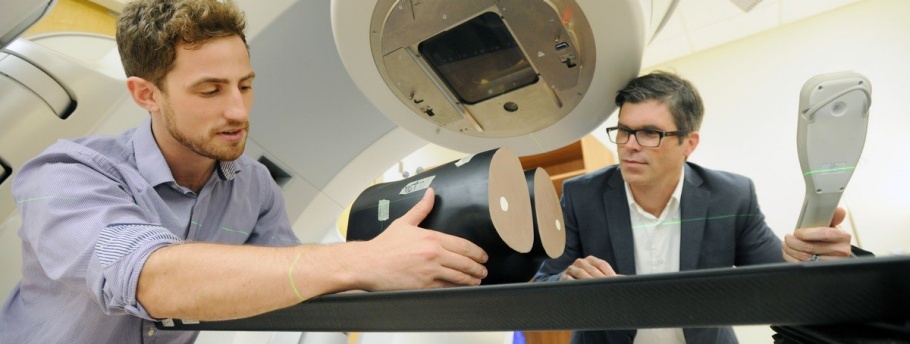 PhD graduate student and supervisor conducting experimental research on linear accelerator